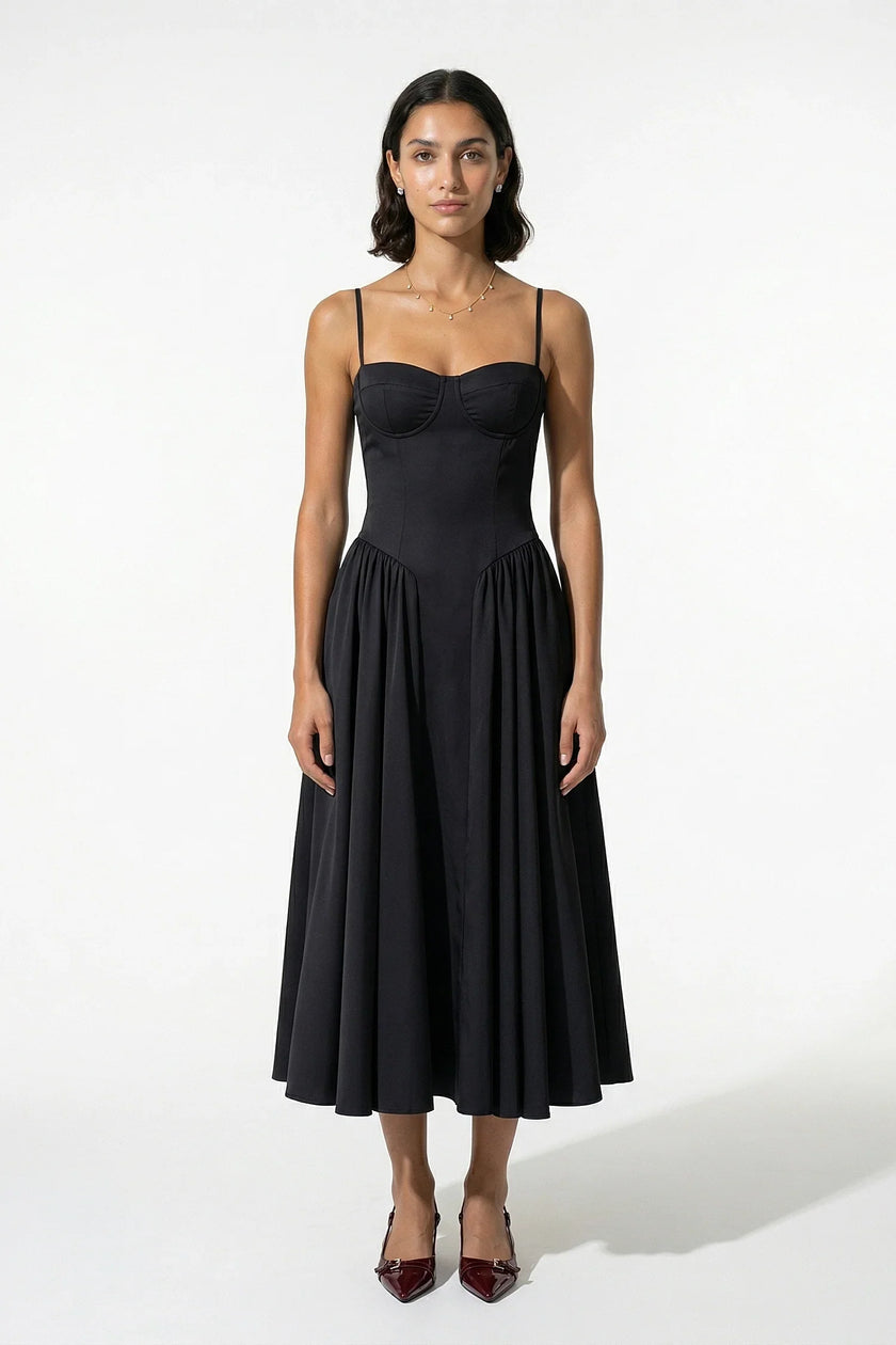 Black FJØRNA sleeveless pleated backless midi dress with halter neck, perfect for occasion wear, shown on a model.