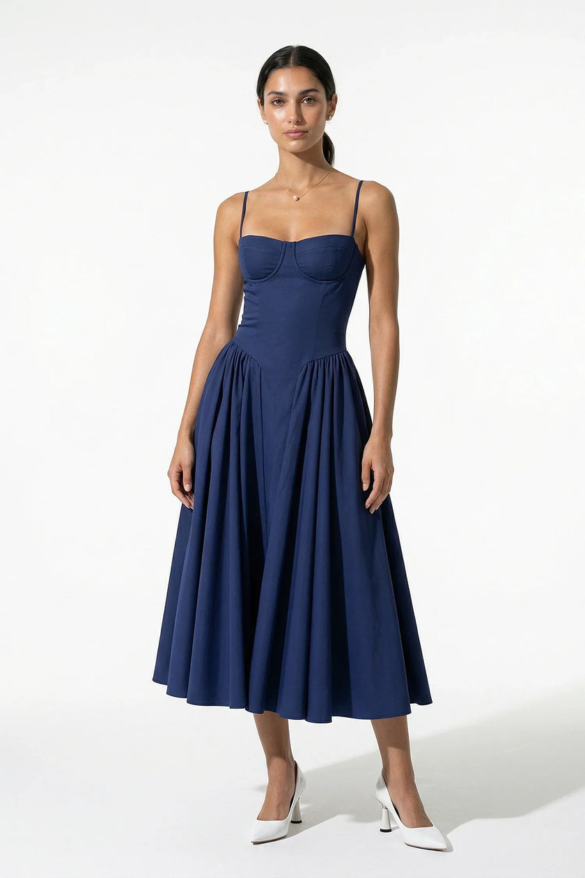 Deep blue FJØRNA sleeveless pleated backless midi dress with halter neckline, perfect for occasions, shown on a model.