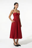 Red FJØRNA pleated halter backless midi dress, sleeveless occasion dress shown from full body, elegant and stylish for events.