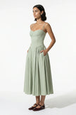 FJØRNA sage green sleeveless backless pleated midi dress with halter neckline, perfect for occasion wear, full body view.