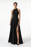 Black FJØRNA sleeveless maxi dress with high neck and side slit, featuring an A-line silhouette and elegant sleeveless design.