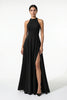 Black FJØRNA sleeveless maxi dress with high neck and side slit, featuring an A-line silhouette and elegant sleeveless design.