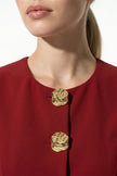 Deep red women's sleeveless waistcoat by FJØRNA with metal buttons, featuring tailored fit and layering style.