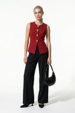 Women’s deep red sleeveless waistcoat by FJØRNA with metal buttons, stylish layering piece, full-body view.