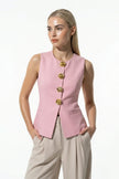Pink women's sleeveless waistcoat by FJØRNA with tailored fit and metal buttons, perfect for layering and stylish outfits.