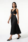 FJØRNA black pleated V-neck maxi dress with cut-out waist, suspender style, full-body view for occasion wear