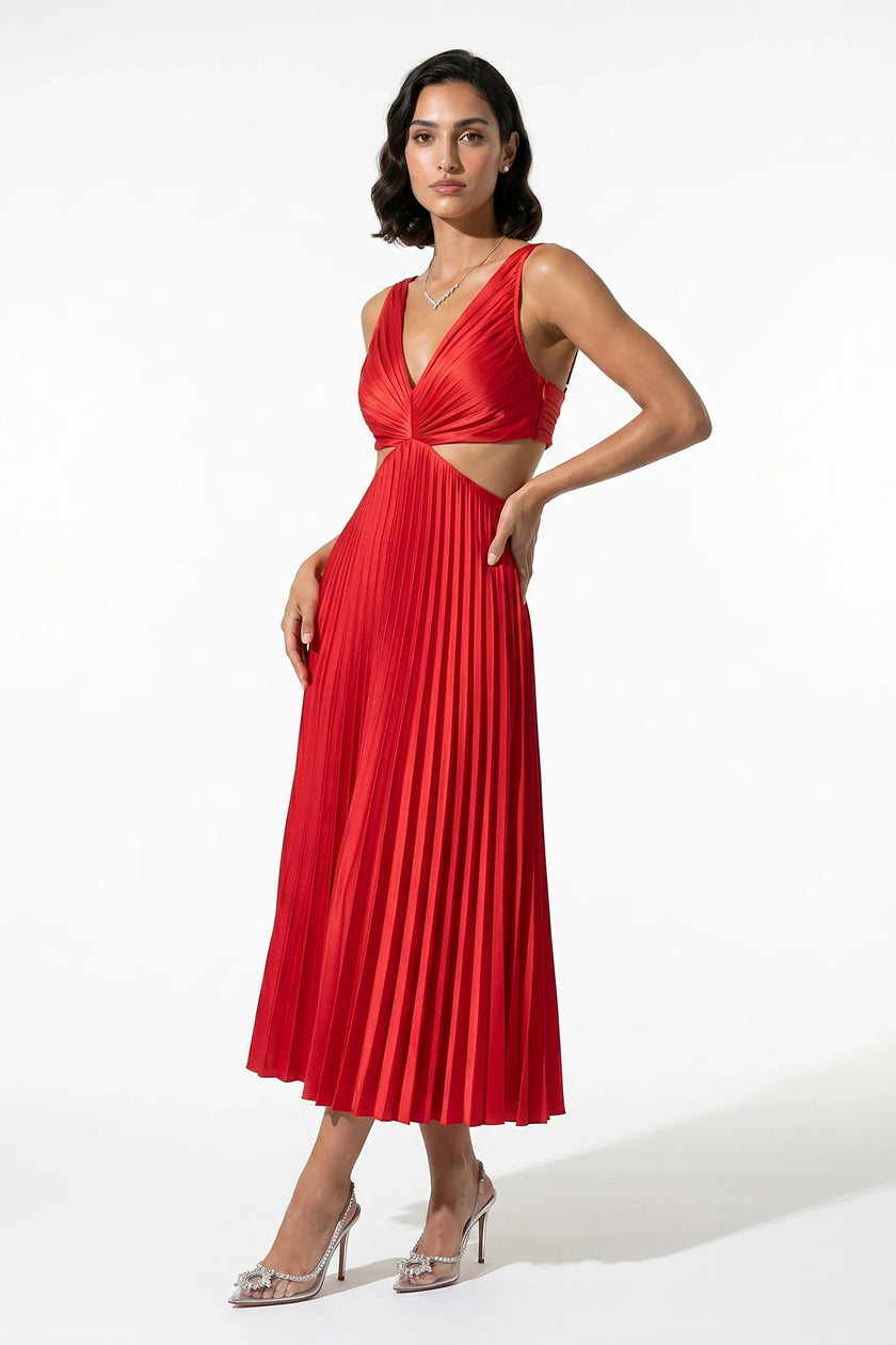 Red FJØRNA pleated V-neck maxi dress with cut-out waist, featuring suspender straps and full-length flowing design.