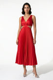 Red FJØRNA pleated V-neck maxi dress with cut-out waist, perfect for special occasions, shown with suspender detail.