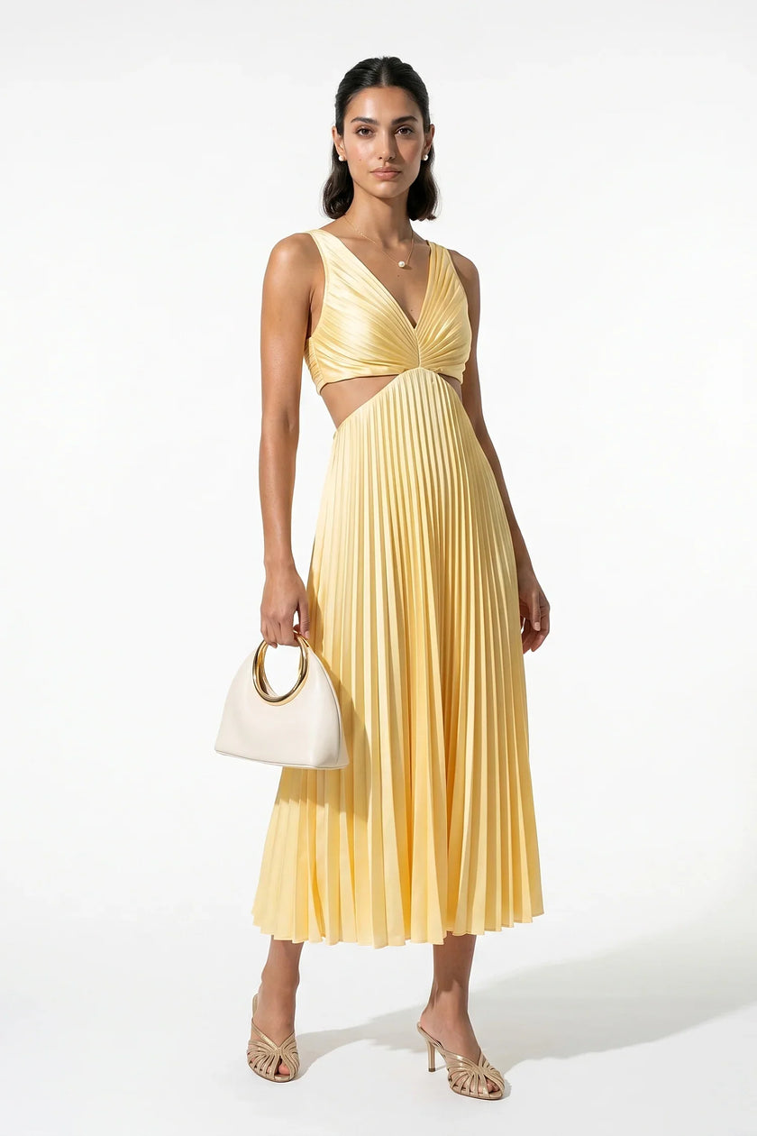 Yellow pleated V-neck maxi dress with cut-out waist by FJØRNA, full-body view showing suspender-style details.