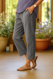 FJØRNA women's lightweight summer trousers with straight leg fit and side pockets, made from breathable fabric for comfortable wear.