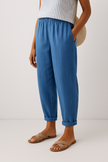 FJØRNA lightweight summer women's trousers with straight legs, breathable fabric, and functional pockets for a casual, stylish look.