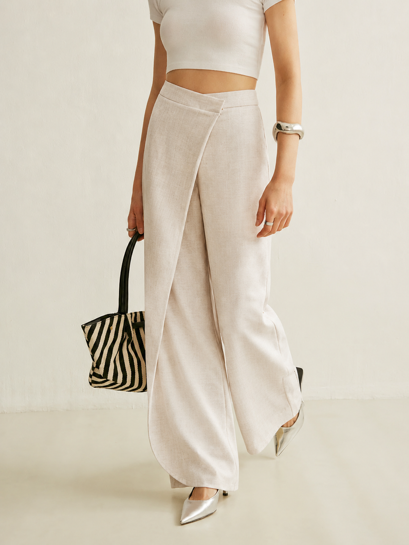 Lightweight summer women's trousers by FJØRNA featuring wide-leg, high-waist wrap style, made from breezy fabric.