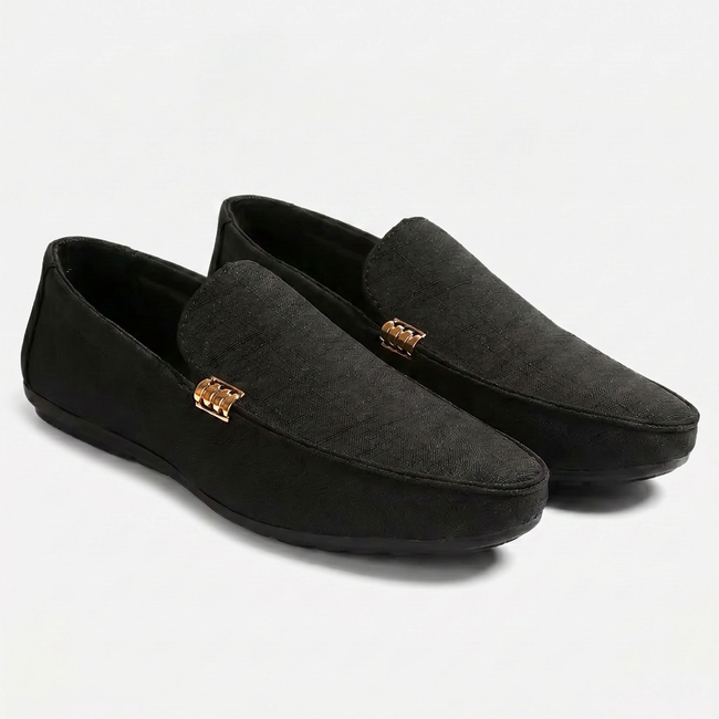 Black men's canvas slip-on loafers by FJØRNA with a sleek, casual design on a clean background.