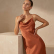 Close-up of FJØRNA elegant women's maxi dress featuring a cowl neck and cami straps, showcasing soft fabric and stylish design.