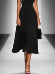 FJØRNA colorblock midi dress for women featuring bold geometric patterns and a stylish, flowing silhouette.