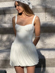 FJØRNA Coquette pleated mini dress for women, perfect for party and day wear, shown in a stylish, flowy design.