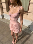 FJØRNA Coquette pleated mini dress for women, featuring a stylish design suitable for both party and daytime wear.