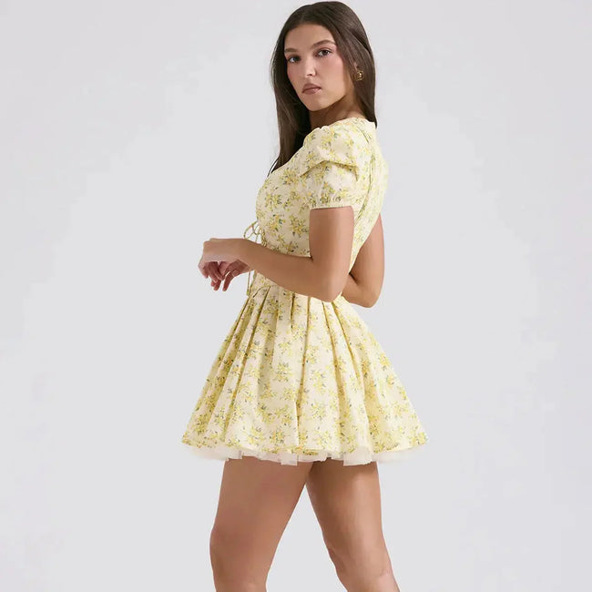 FJØRNA cottagecore floral mini dress with plunge neckline in white, featuring a romantic, vintage-inspired design and delicate floral pattern.