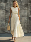 Cream chiffon pleated maxi dress by FJØRNA featuring flowy fabric and elegant pleats, perfect for casual occasions.