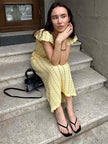 Crochet women's midi dress by FJØRNA with intricate knit pattern, sleeveless design, and mid-length hem, perfect for day to night wear.