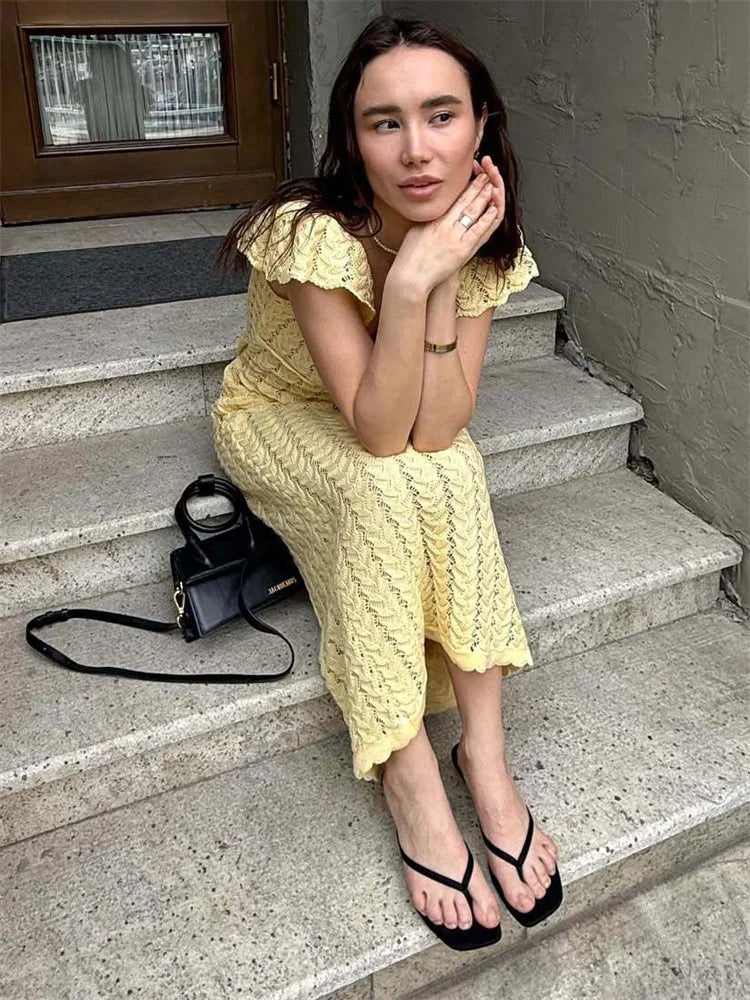 Crochet women's midi dress by FJØRNA with intricate knit pattern, sleeveless design, and mid-length hem, perfect for day to night wear.