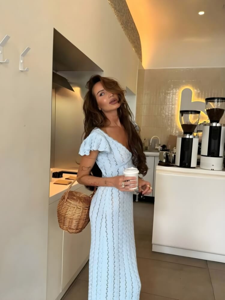 FJØRNA crochet women's midi dress featuring intricate knit pattern, sleeveless design, and flowing silhouette for versatile daytime to evening wear.