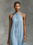 FJØRNA denim sleeveless midi dress for women featuring a fitted bodice and flowing skirt, styled with side pockets and adjustable straps.