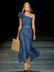 FJØRNA denim strapless maxi dress displayed on a hanger, featuring a flowing design and casual evening dress style.