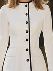 FJØRNA women's dress featuring a flowy fabric, V-neckline, and long sleeves, styled for casual or formal occasions.