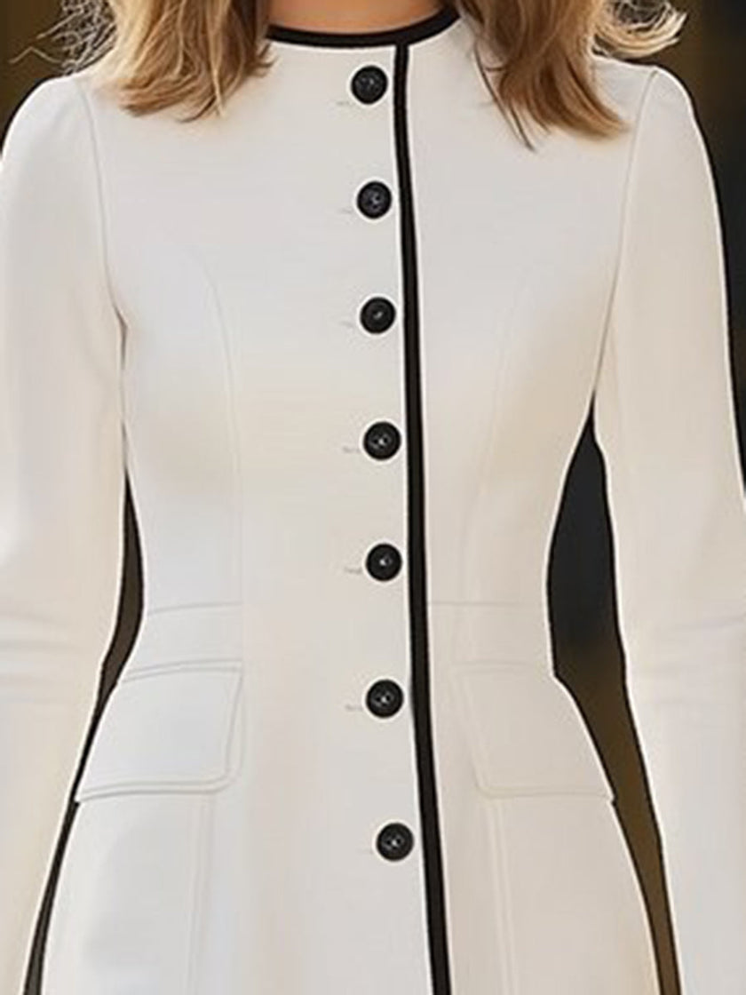 FJØRNA women's dress featuring a flowy fabric, V-neckline, and long sleeves, styled for casual or formal occasions.