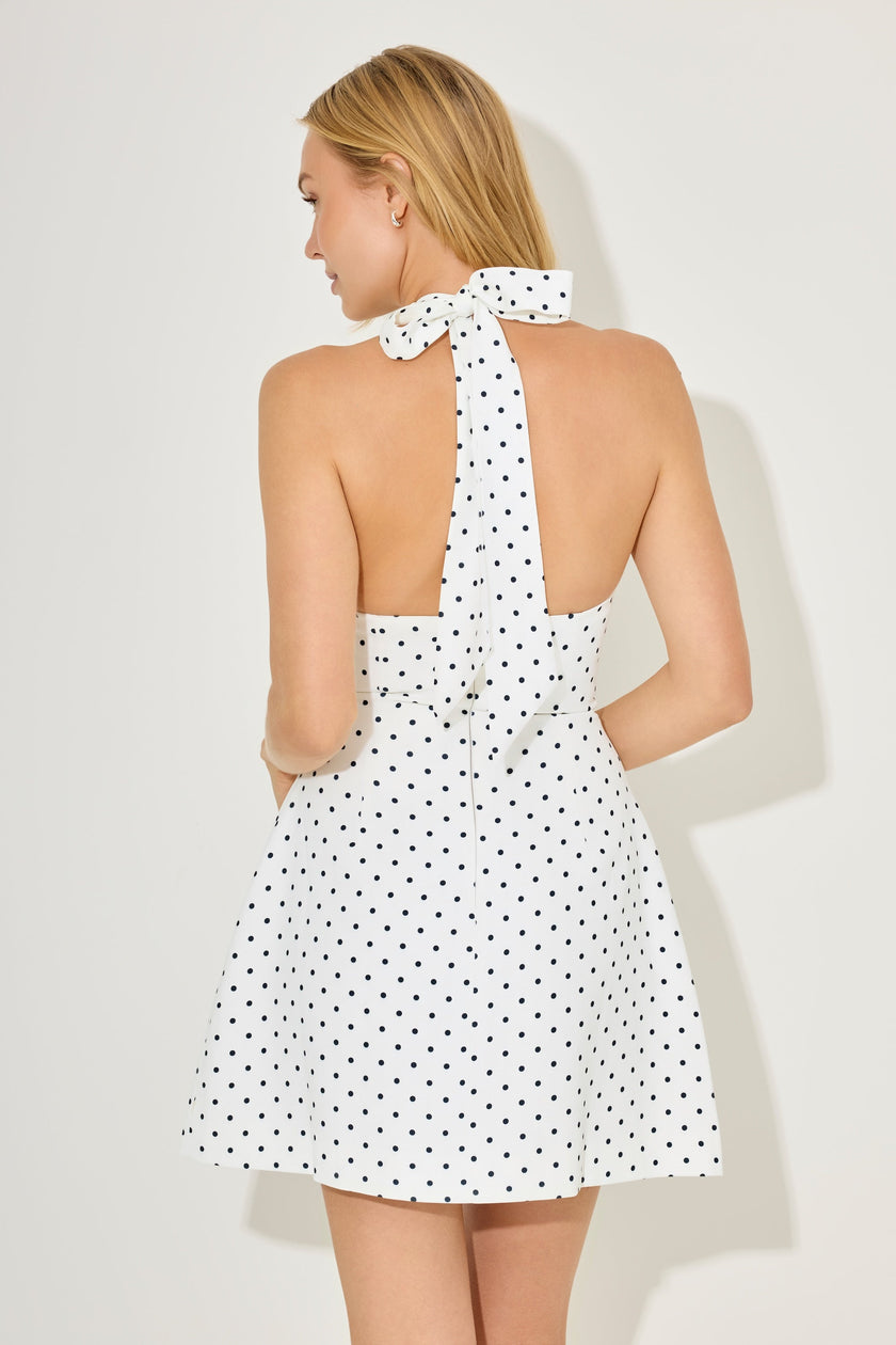 FJØRNA white mini dress with polka dot pattern, stylish volume skirt, perfect for party and day wear.