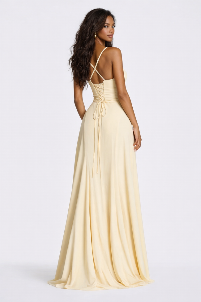 FJØRNA corset-back lace mini dress in elegant pale yellow with intricate lace details and a fitted silhouette.