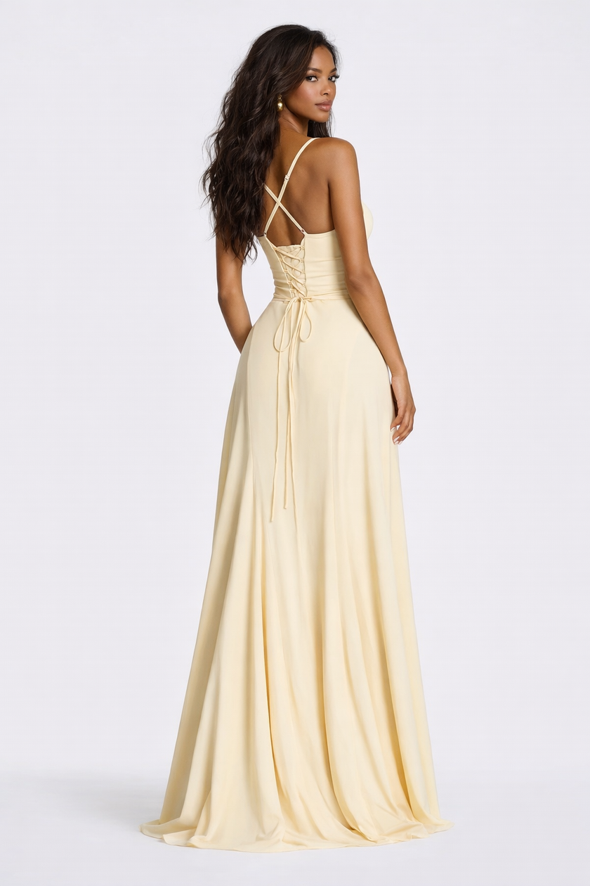 FJØRNA corset-back lace mini dress in elegant pale yellow with intricate lace details and a fitted silhouette.