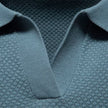 Men's slim fit knit polo shirt by FJØRNA, lightweight and breathable, shown in a close-up of the shirt's fabric and collar.