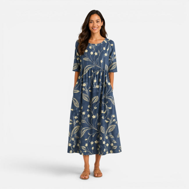 Women's floral midi dress by FJØRNA featuring a spring and summer floral pattern, flowing fabric, and sleeveless design.