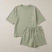 FJØRNA women's summer two-piece co-ord set with pockets, lightweight fabric, laid flat for display.