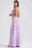 White floral lace-up maxi dress by FJØRNA featuring a flowing silhouette and intricate floral lace details.
