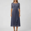 White FJØRNA A-line midi dress with lace bodice, showcasing a flowy skirt and elegant lace details in a stylish dress image.