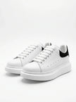 White FJØRNA men's lace-up trainers with minimalist design, ideal for everyday wear, shown from the front view.