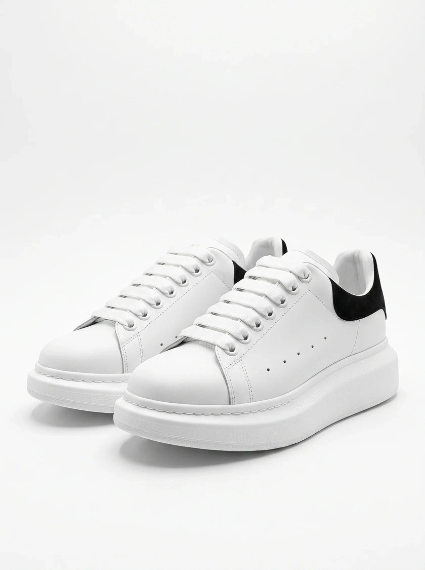 White FJØRNA men's lace-up trainers with minimalist design, ideal for everyday wear, shown from the front view.