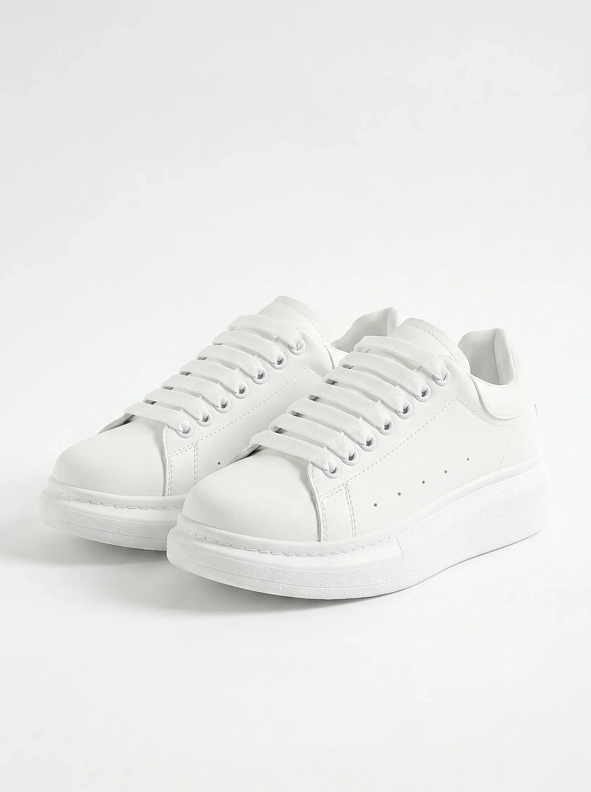 White lace-up men's trainers by FJØRNA, minimalist design, perfect for everyday casual wear, front view of the shoes.