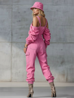 Pink denim strappy tapered long sleeve jumpsuit for women by FJØRNA, featuring a fitted waist and stylish design.