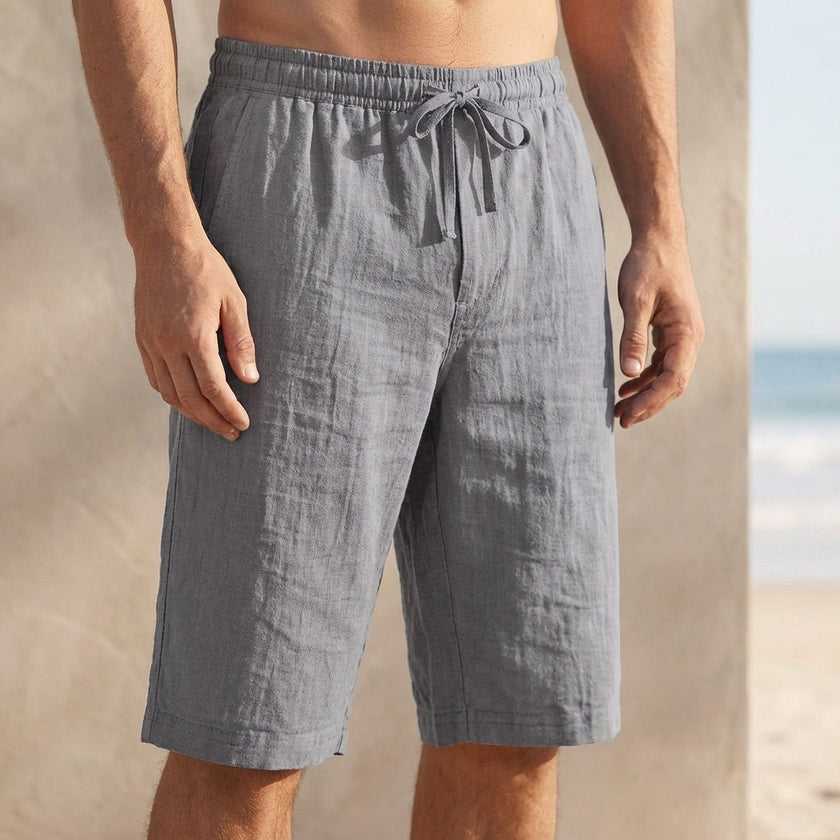 Beige linen drawstring chino shorts for men by FJØRNA, tailored men's pants with a relaxed fit and casual style.