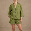 Green women's summer two-piece co-ord set by FJØRNA featuring a button front, V-neck top and matching shorts.