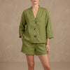 Green women's summer two-piece co-ord set by FJØRNA featuring a button front, V-neck top and matching shorts.