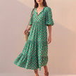 Green FJØRNA women's elegant maxi dress with v-neck and puff sleeves, flowing and stylish for summer occasions.