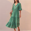 Green FJØRNA women's elegant maxi dress with v-neck and puff sleeves, flowing and stylish for summer occasions.