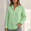 FJØRNA white linen V-neck popover shirt for women, relaxed fit, casual blouse, shown in green fabric with short sleeves.