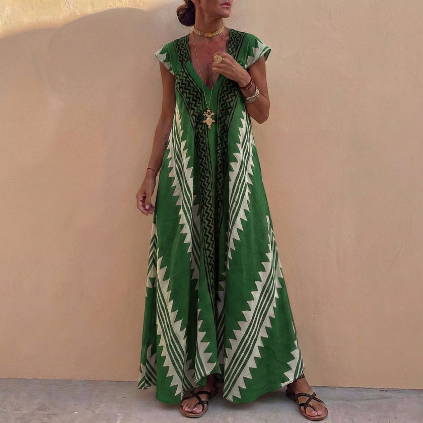 Green geometric V-neck maxi dress for women by FJØRNA, stylish and elegant, shown on a model.