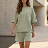 Green women's summer two-piece co-ord set by FJØRNA with pockets, lightweight fabric, perfect for casual warm-weather wear.